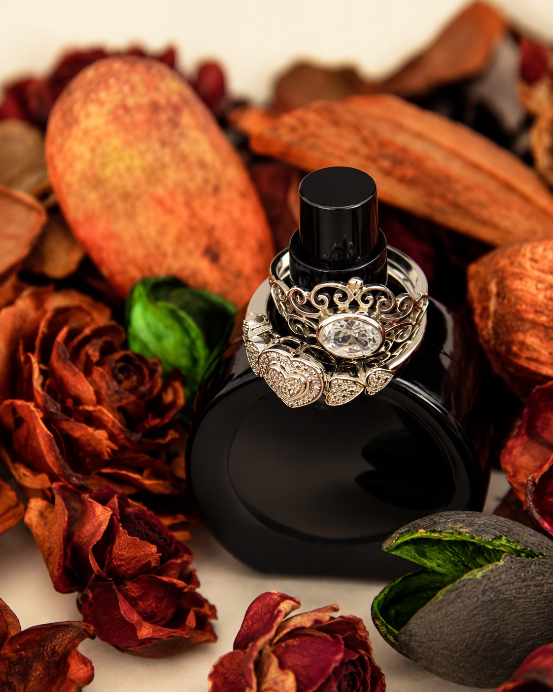 Bespoke gemstone jewellery arranged on a black perfume bottle