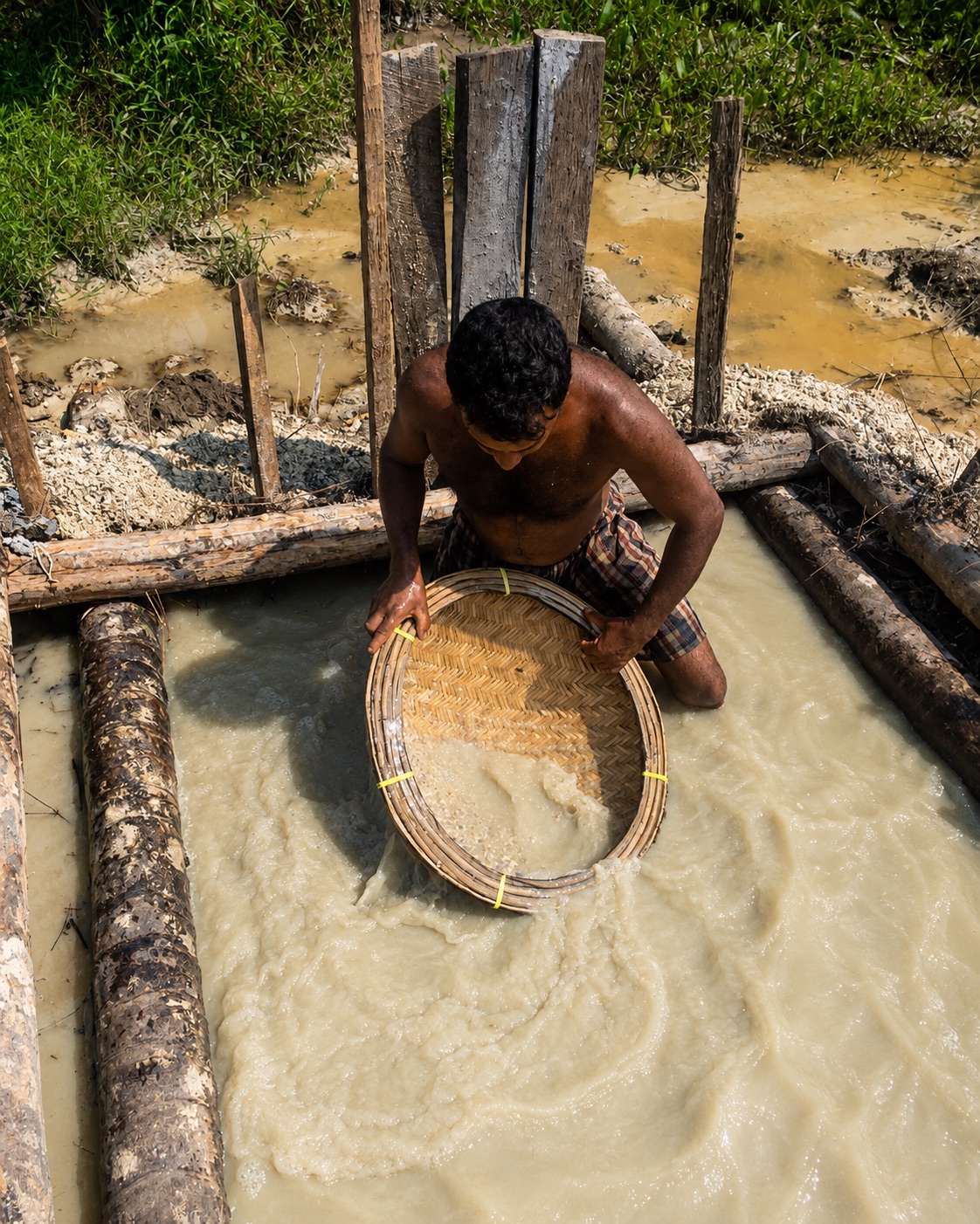 Miner washing gem-bearing earth with a traditional basket